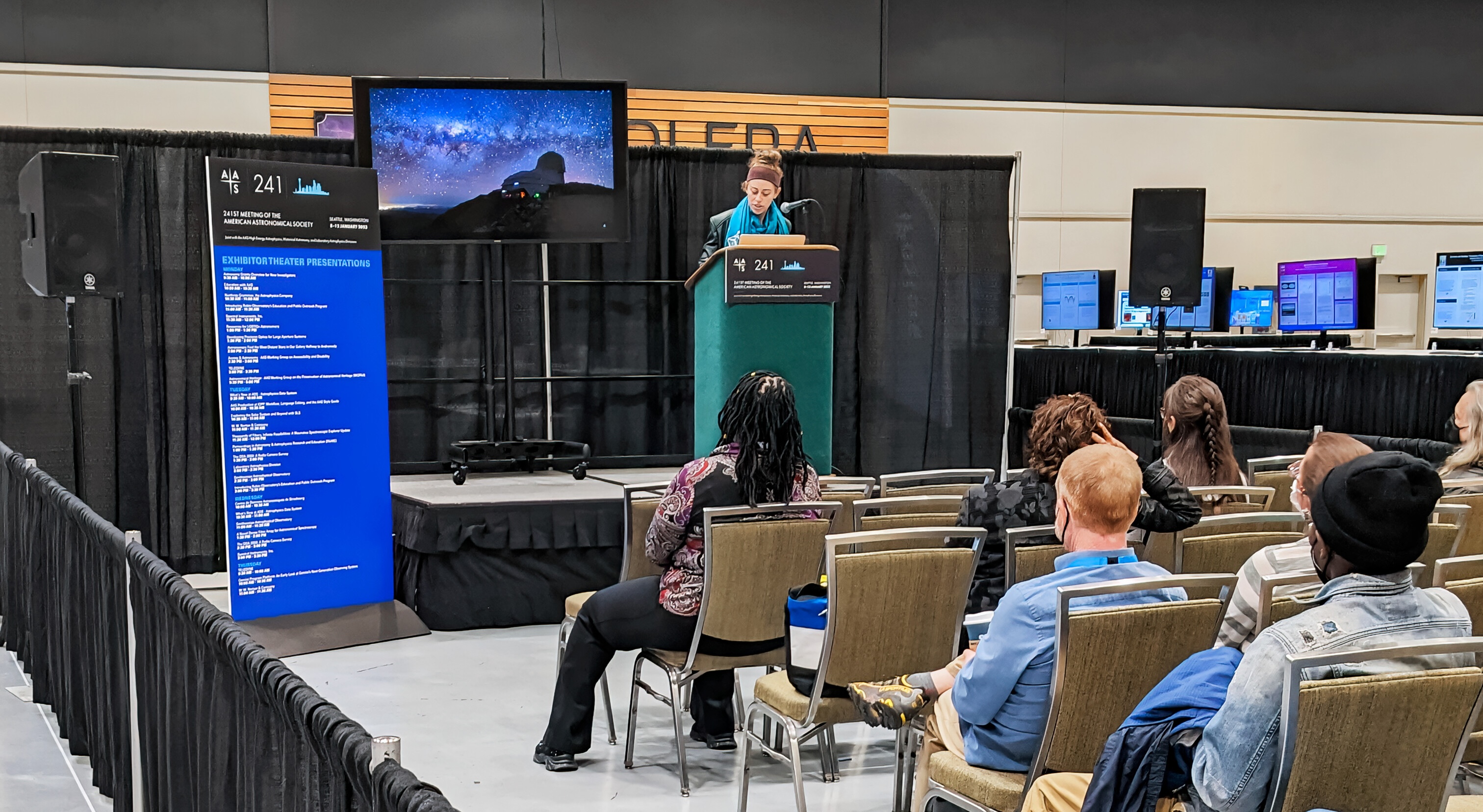 Stephanie giving a talk in front of a blackboard